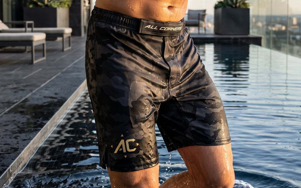 Athlete stepping out of a rooftop pool in ALL CORNERS camo shorts, water shedding off the fabric