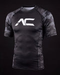 ALL CORNERS grayscale camo compression rashguard with white AC mark on the chest